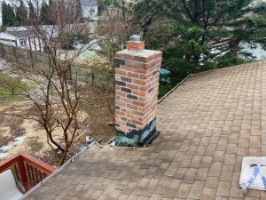 chimney flashing repair in process removing old flashing and tar in long island by agless chimney new york