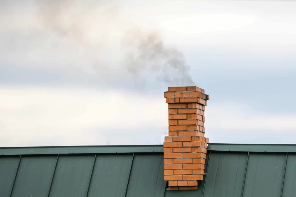 Smoke billowing from chimney during home heating